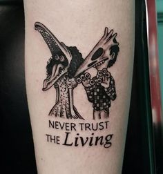 a tattoo on the leg of a man with words never trust the living