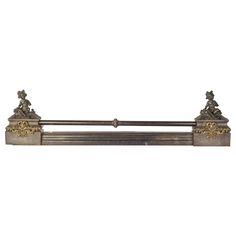 an old fashioned metal shelf with statues on it's sides and gold trimmings