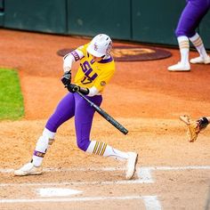 a baseball player swinging a bat on top of a field