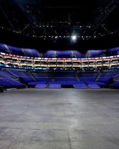 an empty stadium with blue seats and lights