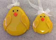 two yellow plastic ducks with bows on their heads