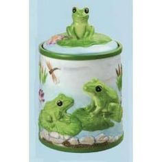 two green frogs sitting on top of a canister