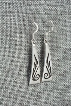 These sterling silver earrings were made by Hopi silversmith Augustine Mowa. The back is stamped sterling.Length: 1 1/2"Width: 3/8"Free shipping on all orders! We ship with USPS and always include tracking. All orders ship within a day of payment.Returns are accepted up to 30 days after you receive your order. Just send us a message. Our shop offers cash back or store credit. The item must be returned in new condition. Symbolic Sterling Silver Pierced Earrings, Symbolic Hallmarked Sterling Silver Earrings, Native American Jewelry, Free Jewelry, Sterling Silver Earrings, Silver Earrings, Stamp, Drop Earrings, Sterling Silver