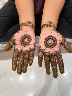 two hands with henna designs on them