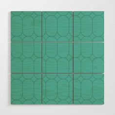 a green tile with circles on it in a square pattern that appears to be made out of wood