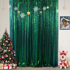 a green curtain with snowflakes and christmas decorations