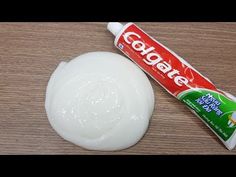 a tube of toothpaste sitting on top of a wooden table