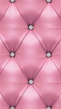 a pink leather upholstered wall with diamond studs on the top and bottom