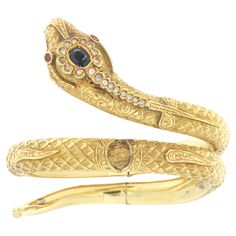 Beautiful 18 karat yellow gold snake bracelet mounted with natural diamonds,sapphire on the head and rubies in the eyes note that the bracelet can be adapted to any wrist size as shown in the video. Snake-shaped jewels always have a particular charm and denote grace, seduction and mystery. In many civilizations, in fact, the snake has had very important meanings, often ambivalent, with references to life and death, good and evil. This is probably linked to the very nature of this animal which us Snake Bangle, Snake Bracelet, Gold Snake, Good And Evil, The Snake, Bangle Bracelet, Natural Diamonds, Bangle Bracelets, Cuff Bracelets