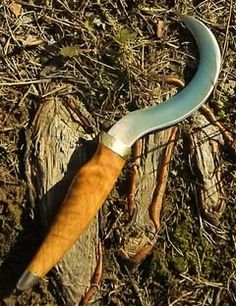 a knife with a wooden handle laying on the ground