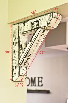 a wooden shelf with measurements for the top and bottom section, hanging on a wall