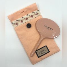 a wooden spoon sitting on top of a piece of cloth next to a tag with the word gucci