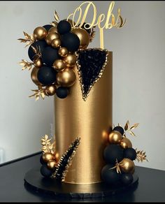 a gold and black cake with decorations on top