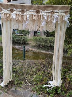 an outdoor wedding ceremony set up with lace and burlucks on the ground