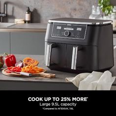 a black and silver kitchen appliance with the words cook up to 25 % more