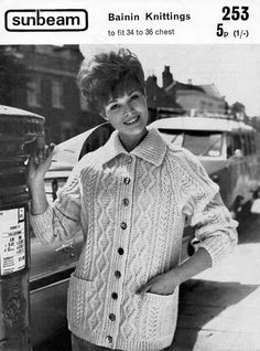 a woman standing next to a parking meter in front of a car wearing a sweater