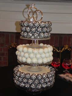 three tiered cake with white and black decorations