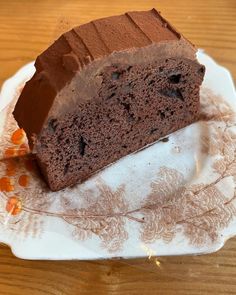 a piece of chocolate cake sitting on top of a white plate