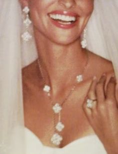 a woman in a wedding dress and veil smiling