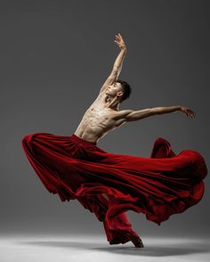 a man in red is dancing on a gray background