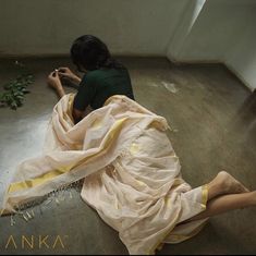 a woman sitting on the floor with her legs crossed