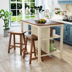 a kitchen island with two stools next to it