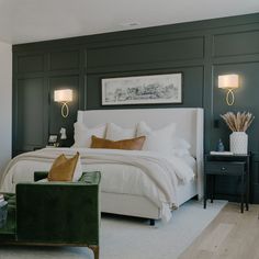 a bedroom with green walls and white bedding