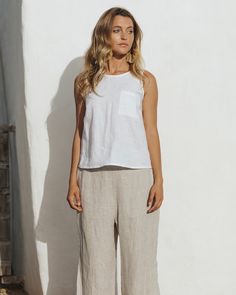 "The sleeveless linen top SILAY should form a part of your summer capsule wardrobe. Its minimal design (sleeveless with decorative front pocket), soft linen fabric, and classic colors (comes in white and natural melange) makes this linen top easy to pair with..everything. Match it with linen pants, shorts, or a skirt, dress it up with accessories and you will end up with many stylish looks. Details: * Sleeveless linen top * Decorative front pocket * Medium weight linen (approx. 200 gsm) * The mo Effortless Summer Tops With Pockets, Effortless Linen Tops With Pockets, Linen Tops With Pockets, Sleeveless Tops With Pockets For Everyday, Casual White Linen Tank Top, Sleeveless Summer Tops With Side Pockets, White Linen Tank Top For Everyday, Everyday White Linen Tank Top, Crop Top Summer