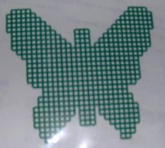 an image of a green and white checkered butterfly sticker on a sheet of paper