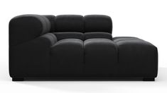 a black couch sitting on top of a white floor