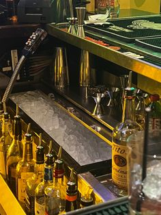 bottles and glasses are lined up on the bar