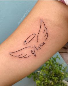 a woman's arm with a tattoo on it that says love and an angel