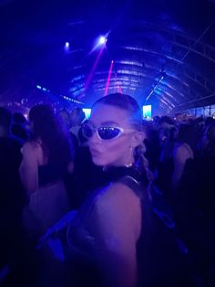 a woman wearing sunglasses at a concert