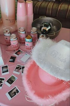 a pink table topped with lots of items