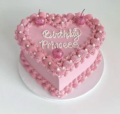 a pink heart shaped cake with the words birthday princess written on it