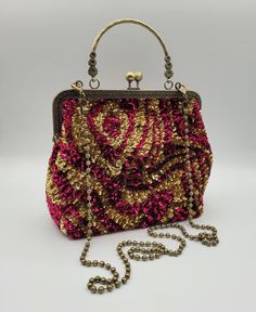 With great pleasure I present this bag, unique piece,entirely made by hands and materials made in Italy. This bag is create with high quality materials such as fabric ,crystals and rhinestones. Each embroidered material is carefully hand sewn. Very glamorous and stylish. Perfect  gift to someone you like.  -------------------------------------------------------------------------- Details: *Metal kiss-lock frame in bronze color long 20 cm (7,8 in) *French vintage sequins. *Lenght of chain 110 cm (43,3 in) *Bag height 20 cm (7,8 in) with handle 28 cm (11,0 in) *Bag width at the bottom 24 cm (9,4 in) *Depth of the bag bottom 10 cm (3,9 in)  The interior of the handbag is lined in black satin fabric with a single pocket enriched with hand embroidered logo, large enough to store cards or lipsti Party Satchel With Mobile Phone Bag, Party Mobile Phone Satchel Bag, Top Handle Mobile Phone Bag For Party, Pink Mobile Phone Box Bag Gift, Gold Box Bag With Top Carry Handle For Gift, Pink Box Bag With Top Carry Handle For Gifts, Top Handle Mobile Phone Bag As Gift, Pink Mobile Phone Evening Pouch Bag, Gold Top Handle Mobile Phone Bag