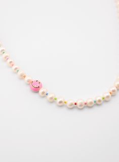 This necklace is designed to brighten your day and elevate your style with a touch of whimsy, making it a unique and unforgettable addition to your jewelry collection. The Smiley Pearl Necklace features a string of luminous pearls, meticulously selected for their timeless beauty and radiant quality. Nestled among these pearls is a captivating smiley face pendant, adding an element of joyful surprise to the necklace. The pendant's cheerful demeanor reflects a sense of optimism and celebrates life Trendy Pearl White Pearl Necklace, Trendy Adjustable Necklace With Pearl Charm, Trendy Pearl Drop Necklaces, Trendy Pearl White Necklace With Pearl Pendant, Trendy Pearl Chain Necklace For Gift, Trendy Pearl Chain Necklace As Gift, Trendy Pearl Charm Necklace Gift, Trendy Pearl Necklace With Pearl Charm As Gift, Trendy Pearl White Necklace With Pearl Charm