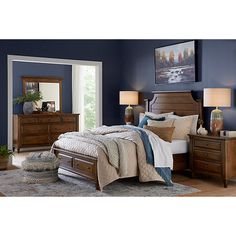 a bedroom with blue walls and wooden furniture