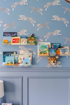 there are many children's books on the shelves in this room with blue walls