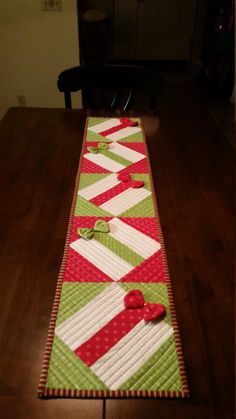 a table runner made with red, green and white strips