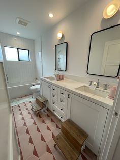 a bathroom with pink and white floor tiles