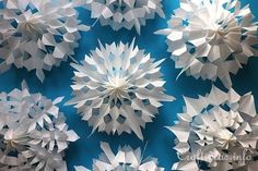 several white paper snowflakes on a blue background