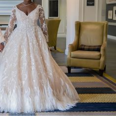 two women in wedding gowns holding hands