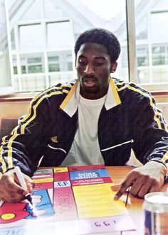 a man sitting at a table with a game in front of him