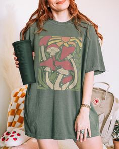 Cute Mushroom Retro Wavy Aesthetic Graphic Tee ️ SIZING & MATERIALS: Printed on Unisex Comfort Colors c1717 garment-dyed t-shirt for a relaxed fit; the fabric brings extra coziness to your wardrobe while the relaxed fit makes it an excellent daily choice.  .: 100% ring-spun cotton .: Medium fabric (6.1 oz/yd² (206.8 g/m *Sizing up 1-2 sizes gives an oversized look* Please compare measurements against our size chart for your perfect fit. Styling ideas - roll up the sleeves, tie a side knot, front tuck, or just wear it as is.  DESIGN/PRINTING: We use DTG (Direct To Garment) Printing which ensures the highest quality of details, color, and durability. *Keep in mind, each shirt is made to order so production and shipping times may vary* Feel free to reach out to us with any questions, includin Aesthetic Graphic Print Tops For Summer, Oversized Cotton Top With Aesthetic Style, Aesthetic Graphic Print Tops For Spring, Summer Short Sleeve Tops With Mushroom Print, Summer Cotton Shirt With Mushroom Print, Summer Mushroom Print Shirt With Relaxed Fit, Relaxed Fit Short Sleeve Shirt With Mushroom Print, Aesthetic Cotton Relaxed Fit Tops, Summer Relaxed Fit Shirt With Mushroom Print