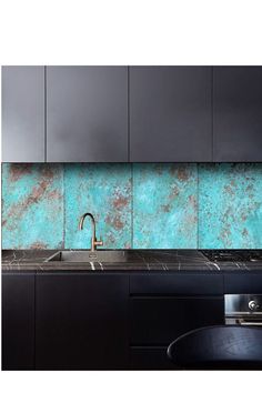 a kitchen with black cabinets and turquoise backsplash tiles on the wall above the sink