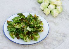 a plate full of brussel sprouts on a table