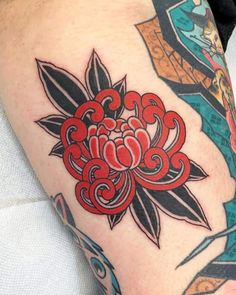 a close up of a person's leg with tattoos on it and an image of a flower