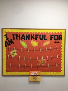 a bulletin board that says i am thankful for with clothes pins attached to it