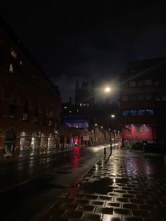 a city street at night with the lights on